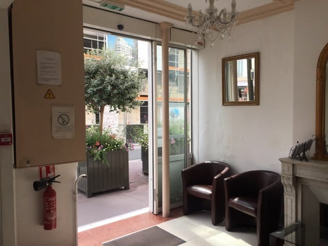 Cramped Hotel Chevallier lounge, small breakout area for professional corporate event venue.