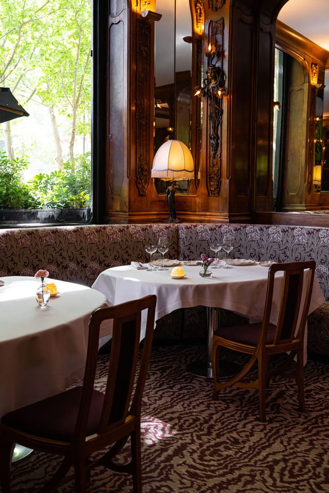 Elegant Lucas Carton restaurant interior with plush banquette seating for VIP and business dining.