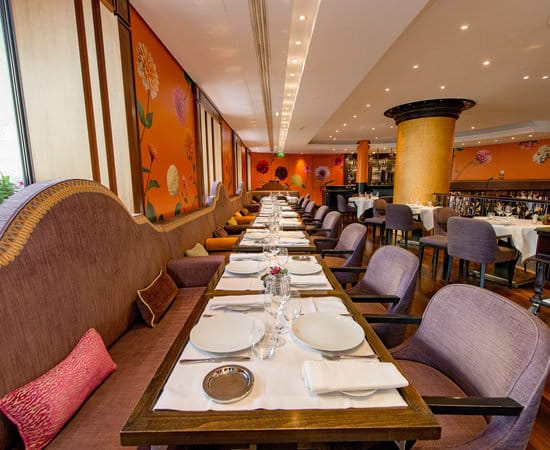 Elegant 114 Faubourg restaurant with booth seating for corporate dinners and celebratory events.