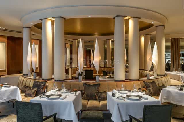 High-end circular banquet space with architectural pillars for corporate dinners and networking.