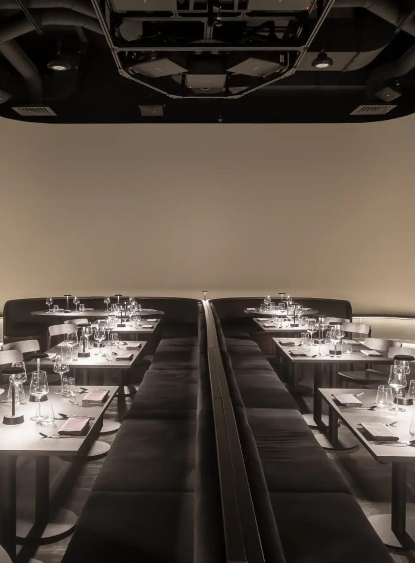 Upscale cocktail bar with dual-sided banquette seating for executive dinners and corporate events.