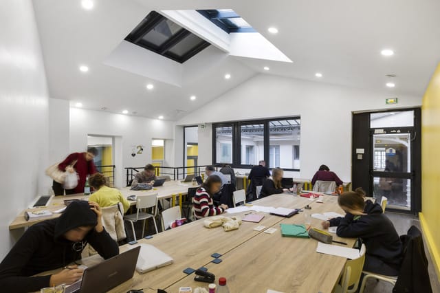 Bright library breakout room for creative workshops and collaborative sessions.