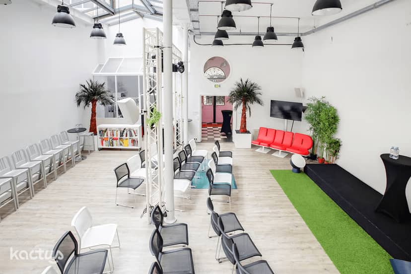 Industrial-chic event venue with stage, ideal for creative workshops and brand activations.