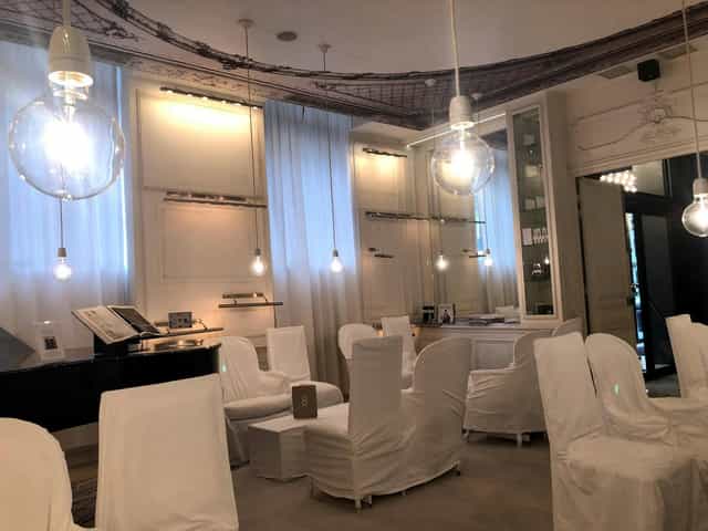 Monochromatic boutique event suite with industrial lighting for networking or private receptions.