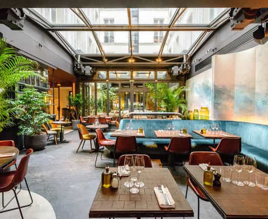 Hôtel National des Arts & Métiers atrium with lush greenery for corporate luncheons and receptions.