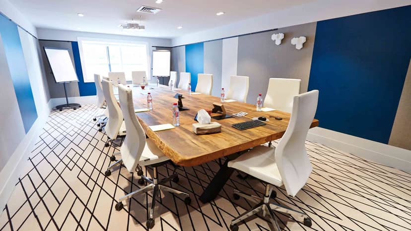 Modern boardroom at Le Cnit with live-edge table for executive strategy meetings.