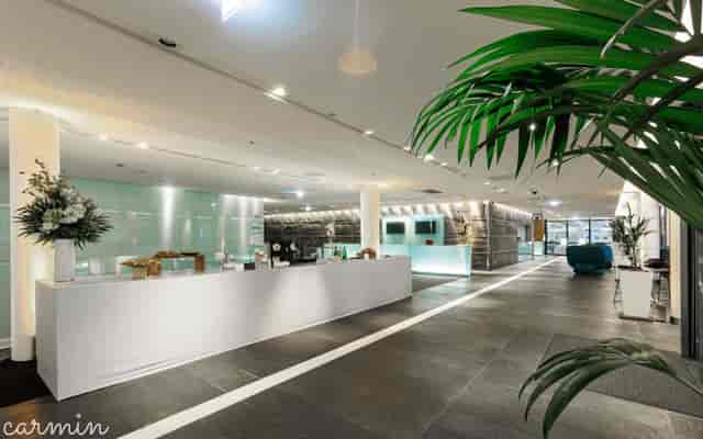 Modern Auditorium HERMES pre-function space for high-end corporate event registration and reception.
