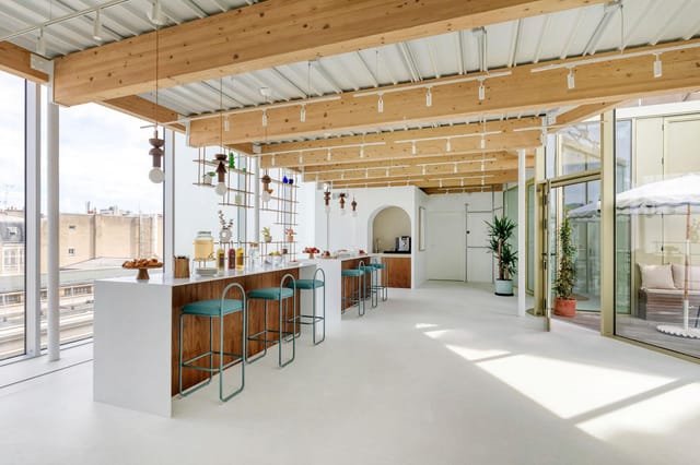 Minimalist Liège Saint-Lazare breakout lounge with high-top seating for corporate event networking.