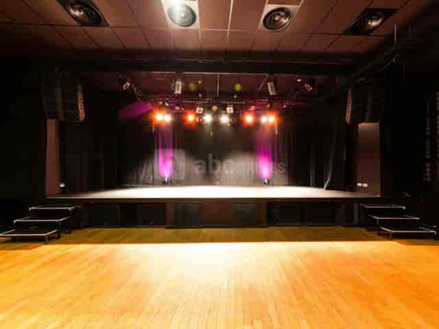 Pan Piper concert hall stage: black-box event space with AV lighting for live performances.