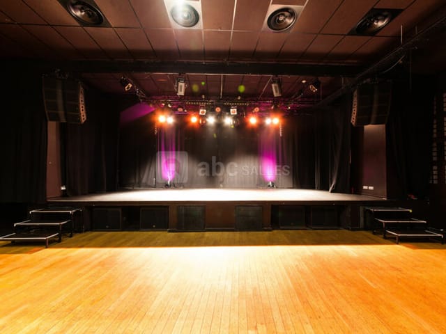 Pan Piper concert hall stage: black-box event space with AV lighting for live performances.