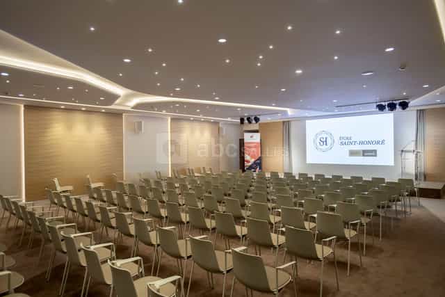 Modern theater-style auditorium with projection screen for seminars and product launches.