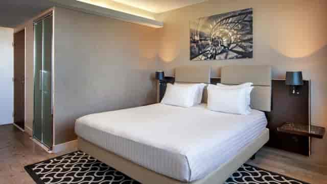 Upscale guest room at La Verrière AC Hotel Paris Porte Maillot for corporate conference stays.
