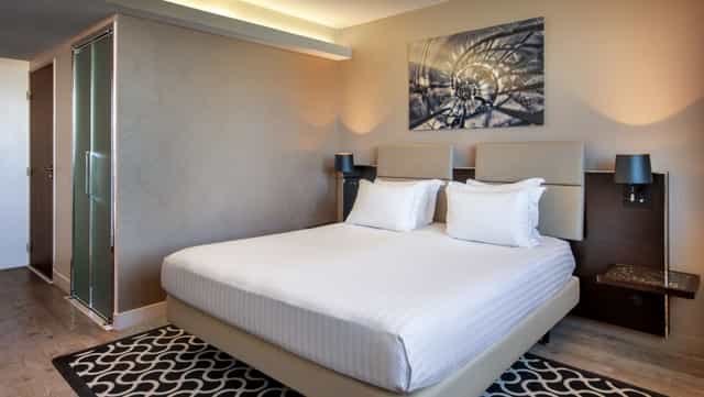 Upscale guest room at La Verrière AC Hotel Paris Porte Maillot for corporate conference stays.