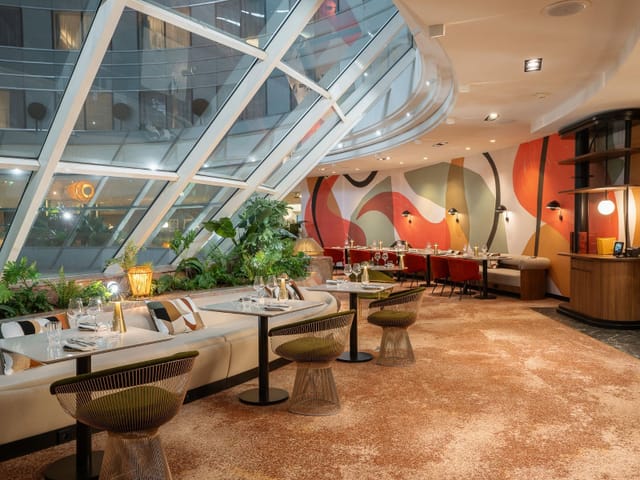 Muses Restaurant dining room with natural light for VIP networking and corporate event breakouts.