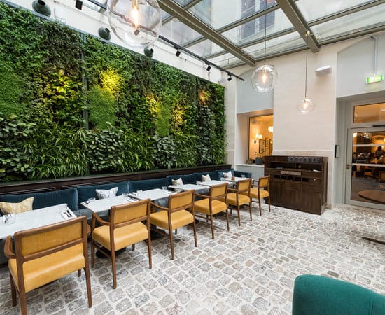 The Orangerie at The Hoxton Paris: light-filled atrium with living wall for networking events.