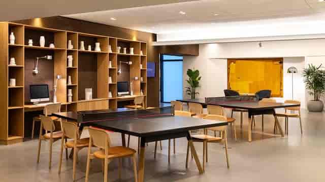 Contemporary breakout space with ping-pong tables for corporate events and team meetings.