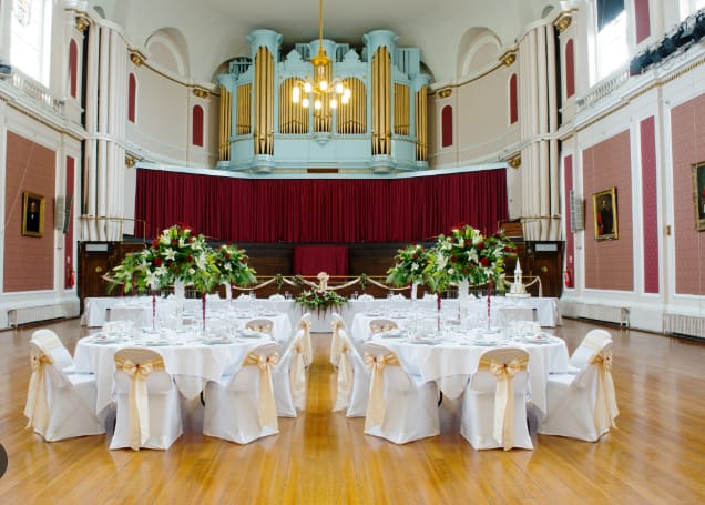 Large Hall venue with pipe organ, set for formal wedding banquet and elegant corporate event.