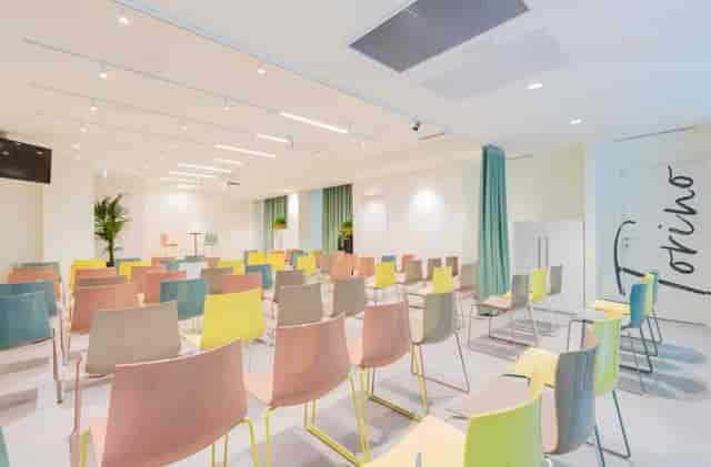 Modern Madrid conference room with colorful theater seating for workshops and creative meetings.