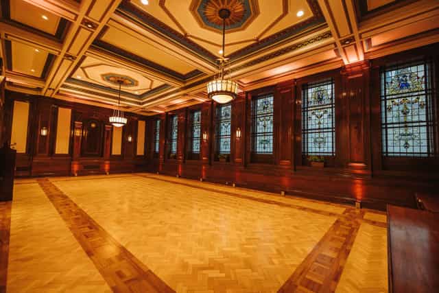 Elegant event space with wood paneling, ideal for corporate meetings and gala dinners.