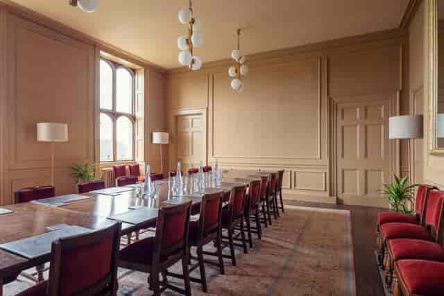 Boardroom at Ashridge House with elegant wooden table, ideal for corporate meetings.