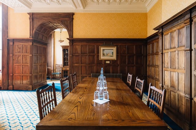 Sitting Room at Ashridge House: elegant meeting space with wooden table for corporate events.
