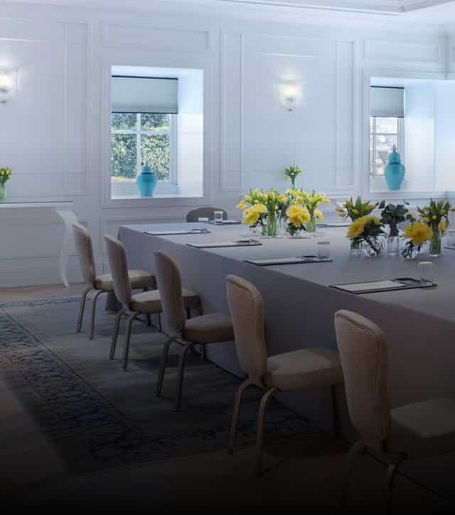 Boardroom at Four Seasons Istanbul: elegant meeting space with crisp linens and floral accents.