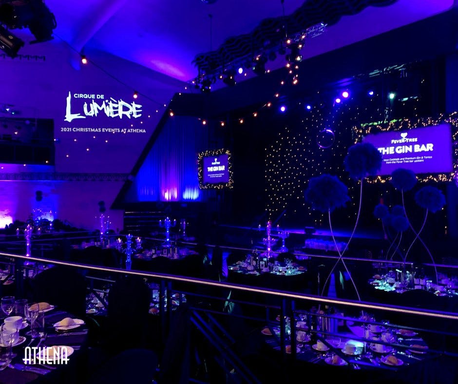 Vibrant event space with elegant decor for a Cirque de Lumière gathering.