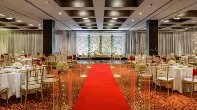 Luxury wedding ballroom with gold chairs and red carpet at Hyatt Regency Dar es Salaam.