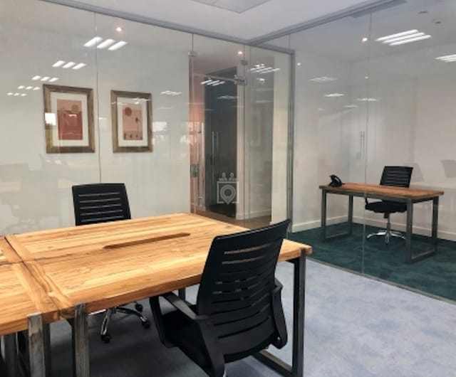 Private offices with glass partitions for coworking space and business meetings.