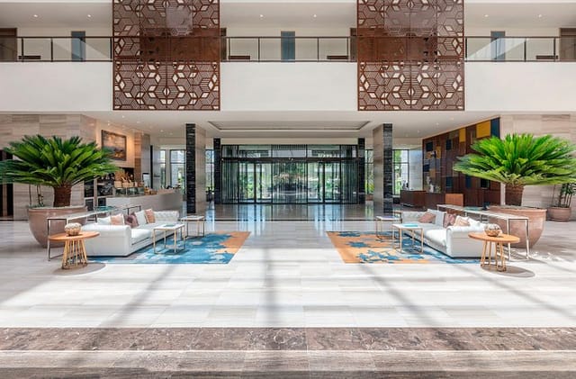 Gran Meliá Arusha hotel lobby: airy, symmetrical space for VIP events and business conferences.
