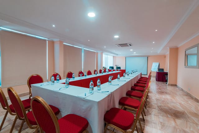 U-shaped conference room in CBD hotel for board meetings and collaborative corporate events.