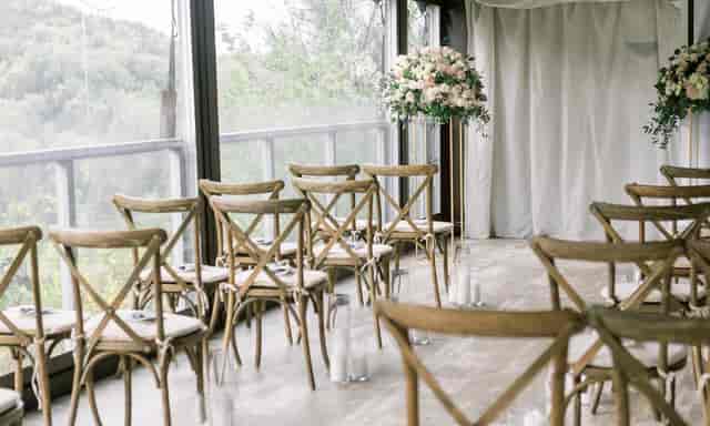 Elegant Wine Cellar Room wedding ceremony at Salish Lodge & Spa with rustic cross-back chairs.