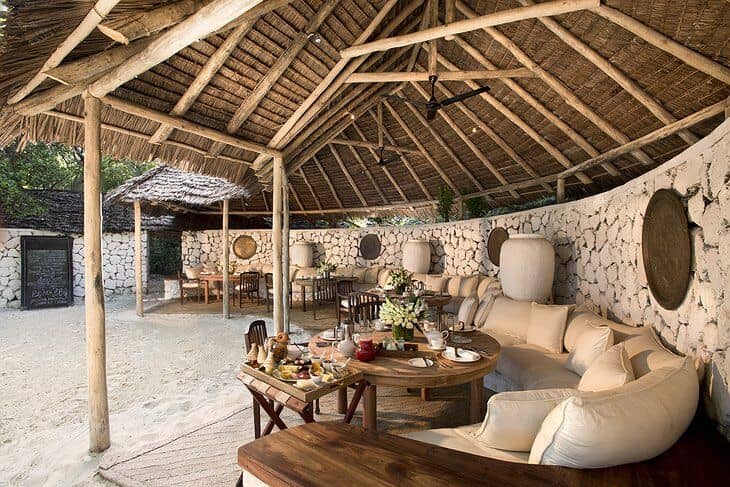 Barefoot-luxe beach lodge with organic decor for high-end incentive retreats and networking events.