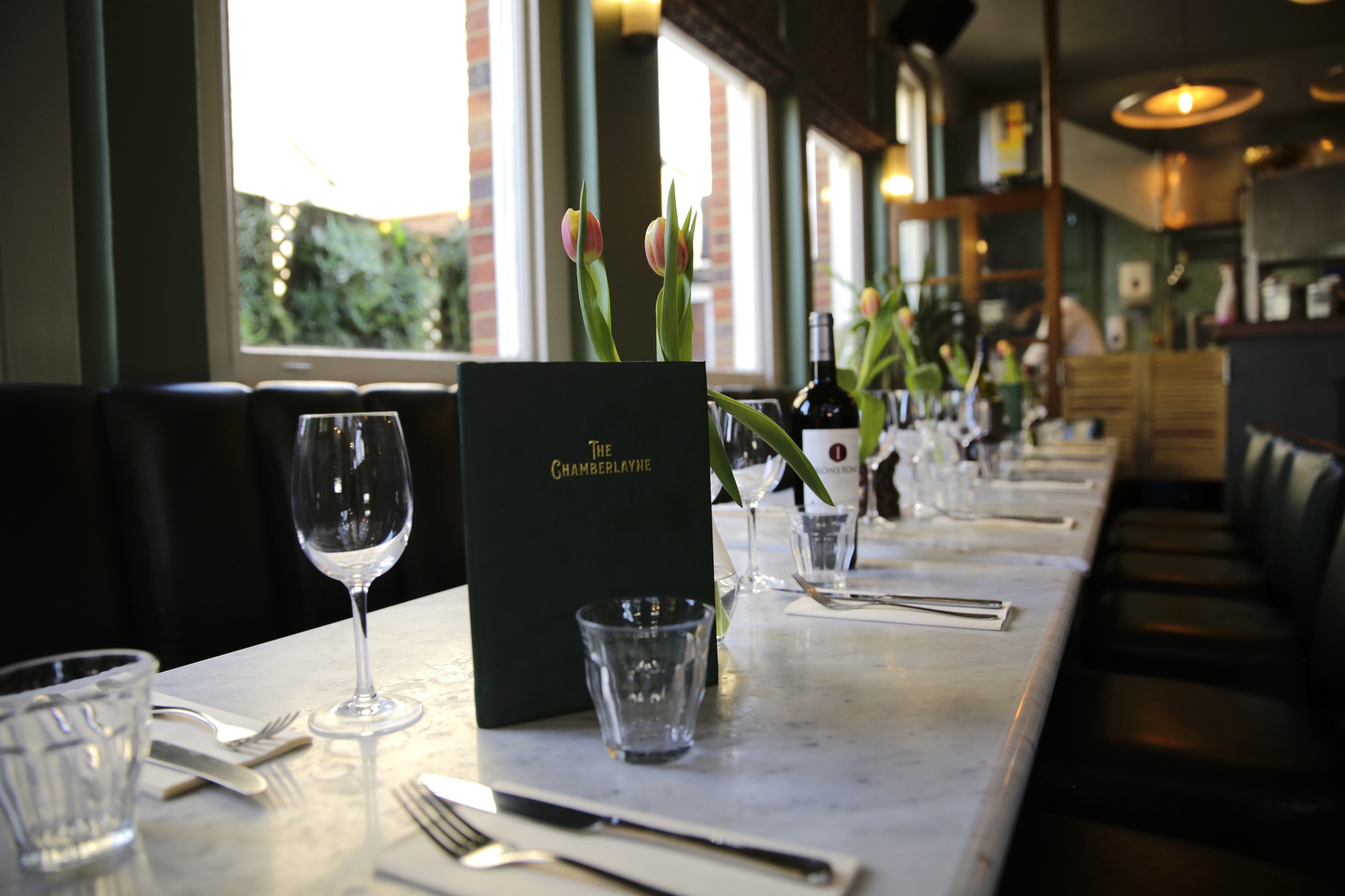 Upscale corporate dinner setup at The Chamberlayne with linear tables for networking events.