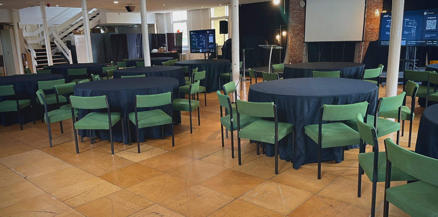 Banquet hall venue hire at All Nations Church Oldham, featuring dark linens and green seating.