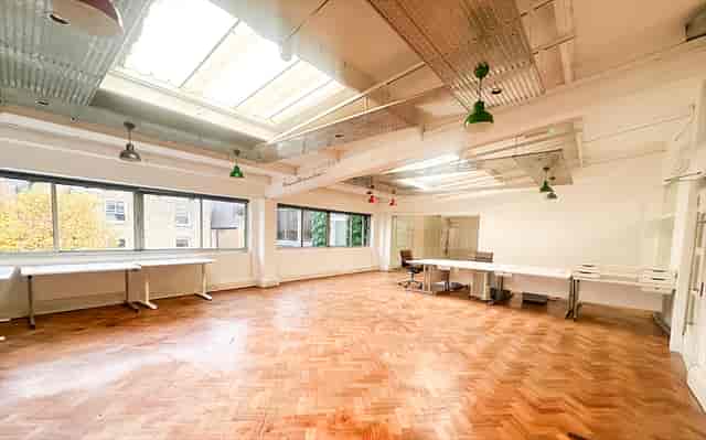 Industrial workspace with herringbone floors, ideal for creative workshops and boutique events.