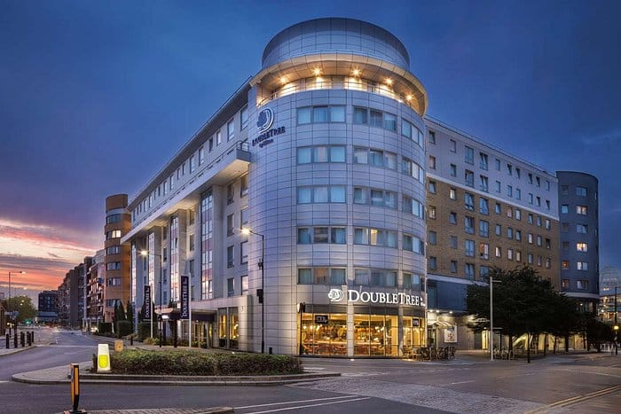 Modern DoubleTree by Hilton London Chelsea hotel exterior at dusk for corporate event room blocks.