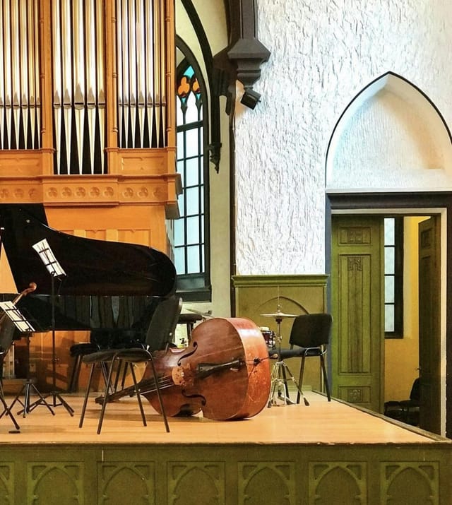 Main Hall at KAPELLHAUS: historic performance venue with modern A/V equipment setup.