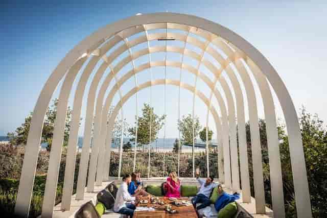 Mukhtarov Boardroom alfresco networking setup with scenic waterfront view for corporate events.