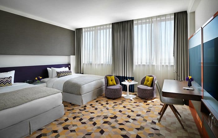 Modern Sheraton Baku Intourist suite with workspace for business travel and corporate events.
