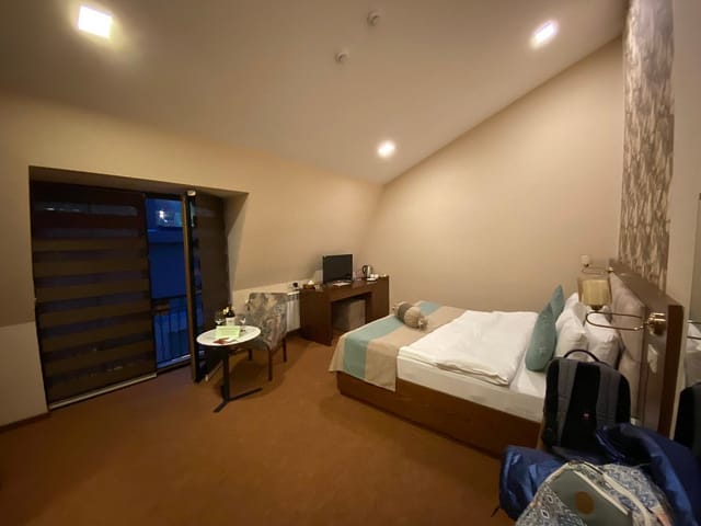 Auroom Hotel conference meeting room with desk and balcony for business events.