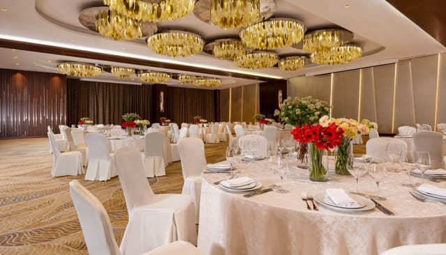Modern ballroom with tiered chandeliers for gala dinner or corporate event in Baku.