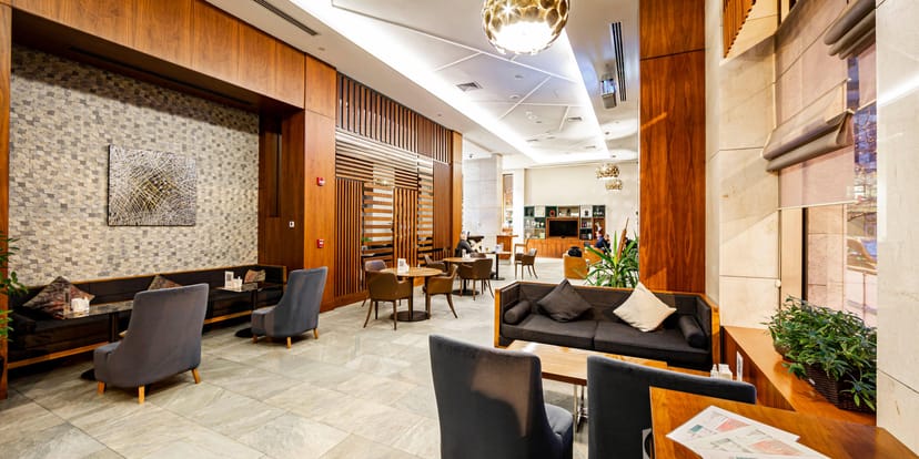 Modern Hotel Baku lobby lounge: sleek, multi-functional space for networking and corporate events.