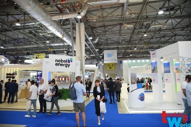 Baku Expo Centre trade show floor with branded exhibits and signage for event wayfinding.
