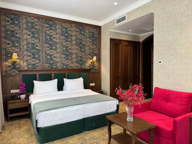 Luxury hotel room in Baku with king bed and lounge area for VIP stays or executive accommodation.