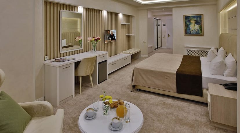 Modern Ganjali Plaza hotel room with workspace for corporate business travel and conferences.