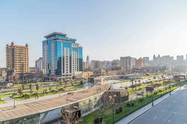 Mövenpick Winter Park Baku modern glass hotel with outdoor plaza for corporate conferences.