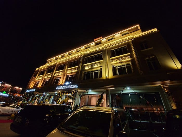 Boutique restaurant at Supreme Hotel, warm evening facade, ideal for corporate retreats and events.