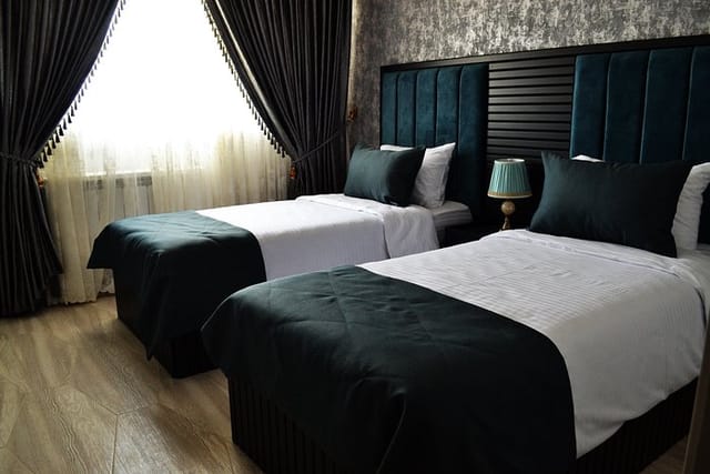 Twin-bedded room in Supreme Hotel for conference delegates and business events.