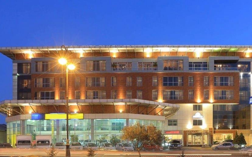 Modern Wyndham Baku hotel exterior at golden hour for corporate meetings and event venue booking.